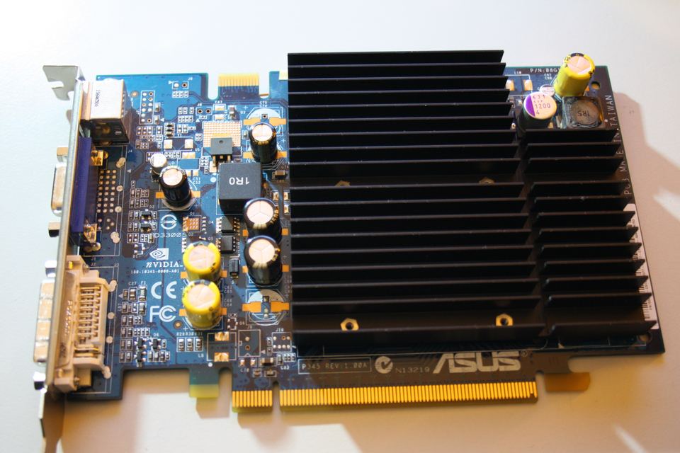 Representative ASUS GeForce 7650 GS PCIe partner board with voltage modification physical card, photographed from the front