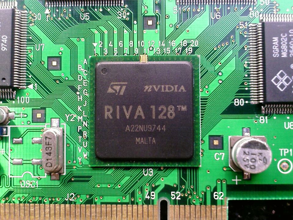 Close-up of an NVIDIA RIVA 128 GPU chip mounted on a green graphics board